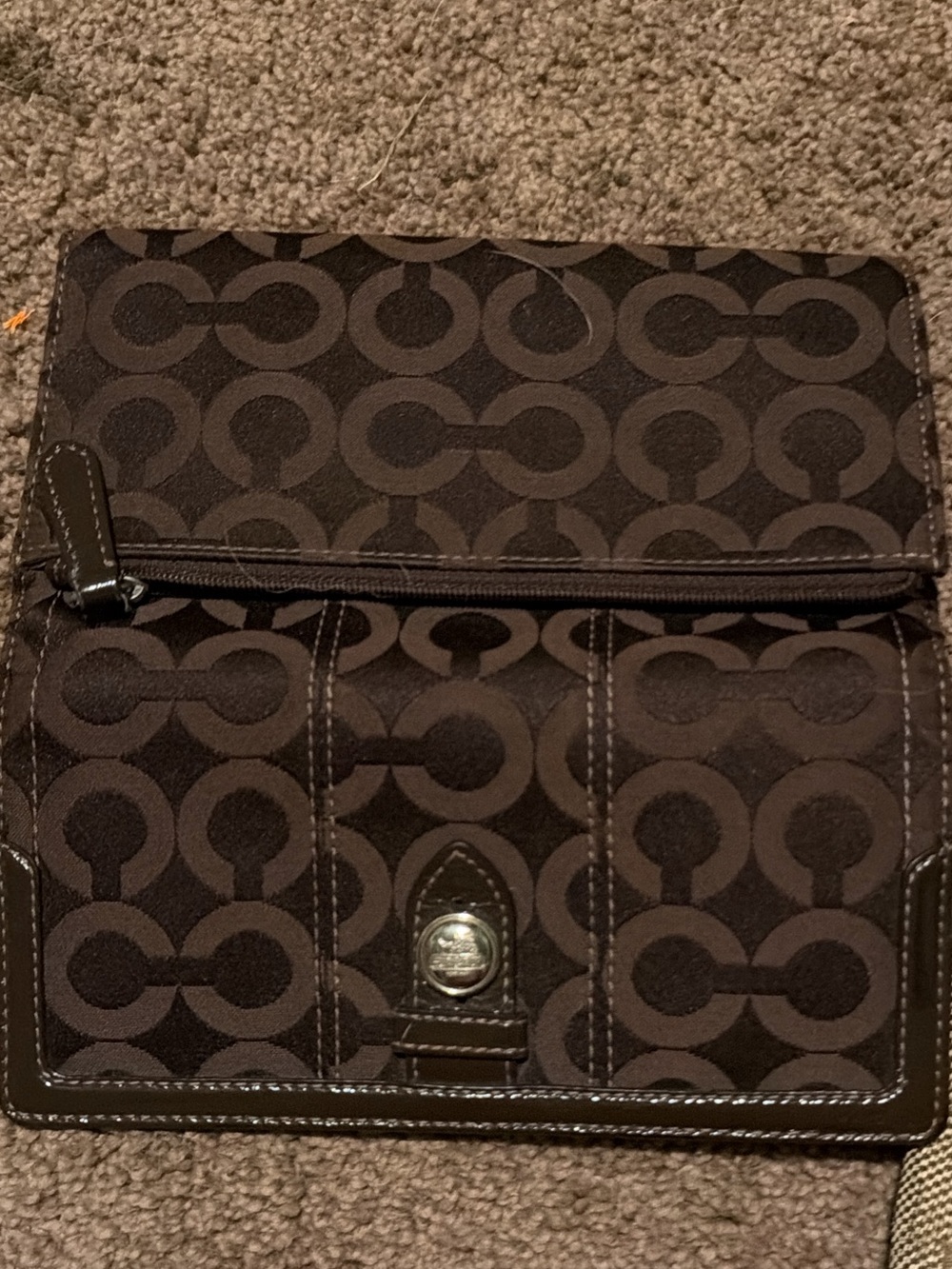Coach Signature Pattern Foldover Wallet in Dark Brown and pink inside.